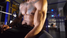 Muscular afro american sportsman training his biceps with dumbbell at sport club. Sporty african man pumping muscles at modern gym. Athletic black guy exercising at fitness centre. Healthy lifestyle - Powered by Shutterstock - Get 15% off with code: PIKWIZARD15