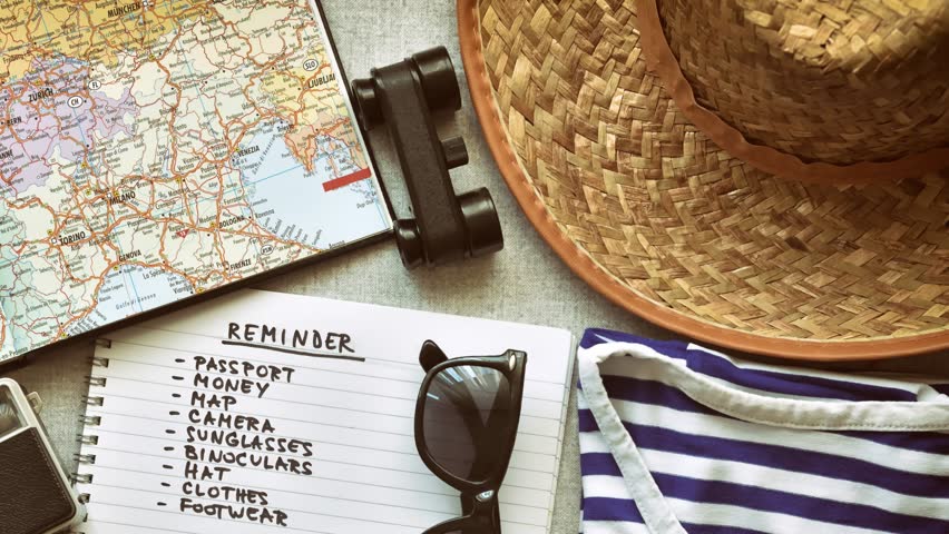 Vintage travel accessories and checklist. Retro style. Top view. Tracking shot.