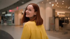 Back view happy Caucasian redhead girl woman lady female stylish attractive businesswoman turning looking at camera smiling friendly enjoying stroll shop having fun indoors modern shopping mall store - Powered by Shutterstock - Get 15% off with code: PIKWIZARD15