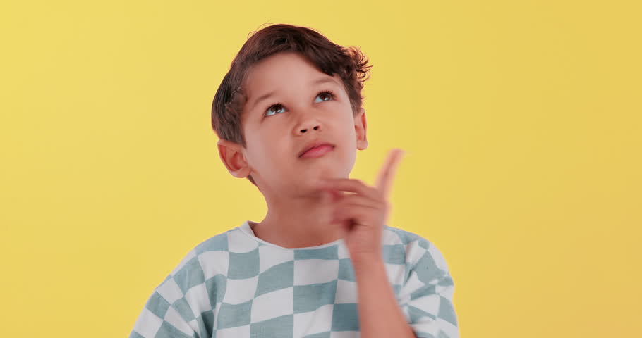Child, question and thinking or idea on studio background with confused face for education or learning. Student or boy in doubt, trying to remember or process information with memory, ADHD or autism