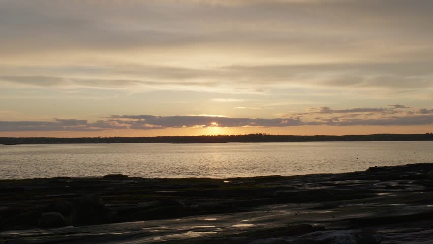 Sunset From Maine Island with Clouds and Rocks. Jenny Island, Maine, USA. Summer 2024