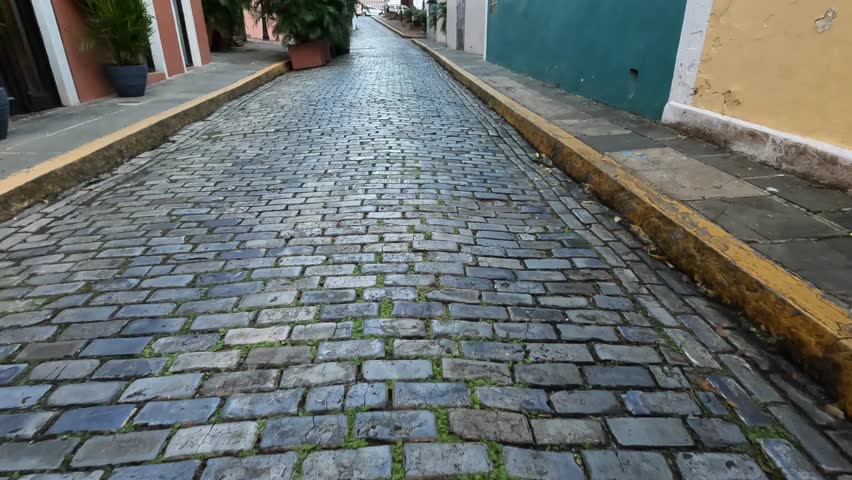 walking along a cobblestone street in old san juan puerto rico (blue paved stones)