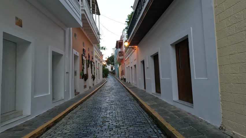 walking along a cobblestone street in old san juan puerto rico (blue paved stones)