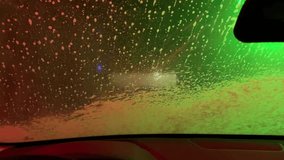 A car window is covered in foam and has a green and orange tint. The car is parked in a parking lot - Powered by Shutterstock - Get 15% off with code: PIKWIZARD15
