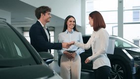 Happy couple family man woman buyers clients greeting handshaking with female girl manager consultant conclude deal buy new auto buying car credit bank choosing automobile rent agent salon dealership - Powered by Shutterstock - Get 15% off with code: PIKWIZARD15