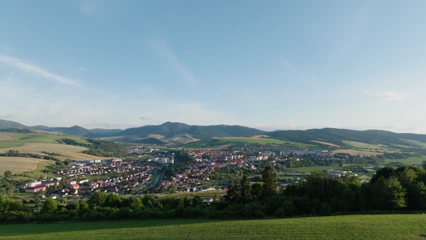 Aerial drone view of Stara Lubovna city in Slovakia on sunny day. Panoramic view of small city between mountains.	(4K)