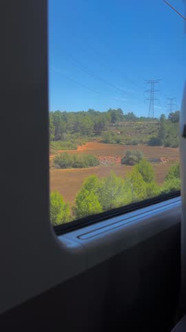 Window View on High-Speed Rail Train from Madrid to Barcelona. A view from a train window. Landscape