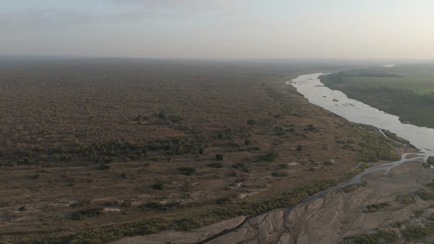 Slow descent onto the Crocodile River in South Africa’s Kruger Park early morning, aerial push-in.