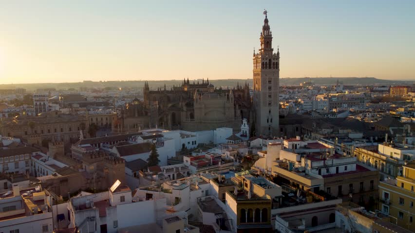 Sevvile Spain, Cathedral of Saint Mary of the See, AKA Seville Cathedral. Beautiful sunset. Majestic bell tower and the surrounding old town, including the nearby Royal Alcázar Palace. España