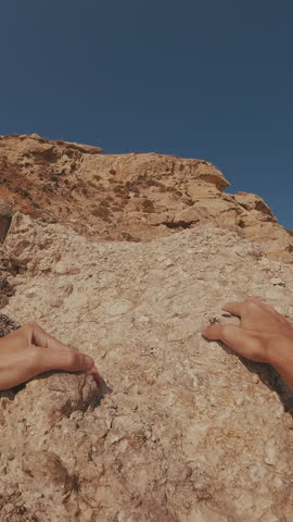 Vertical video, First person video, man climbs up coastal rock, looks around, opens his hands and falls into water, Split level, POV underwater shot, Close up, Mediterranean sea, Greece