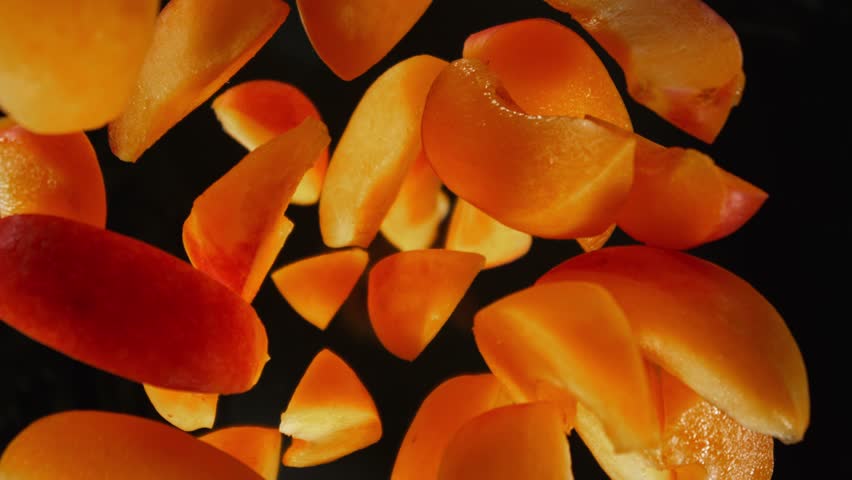 Super Slow Motion of Falling Apricots Slices into Water. Filmed on High Speed Cinema Camera, 1000fps, Placed on High Speed Cine Bot. Camera in Motion, Following Objects.