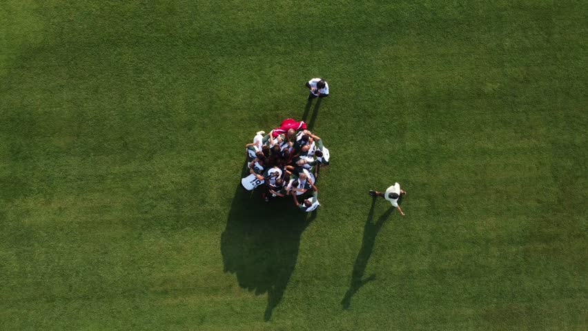 Aerial view of soccer team huddle on field, then dispersing into positions. Shows teamwork and unity. Ideal for sports themes - Powered by Shutterstock - Get 15% off with code: PIKWIZARD15