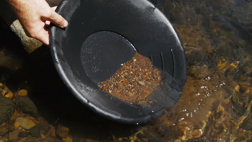 close up of washing gravel from a gold pan