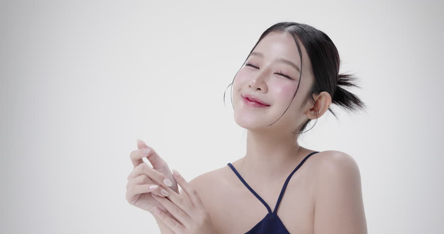 Close up portrait beautiful young Asian woman with healthy facial skin isolated over white background.