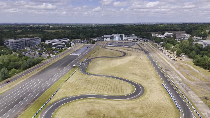 Weybridge, Surrey  UK -  06272024: Drone footage of the Mercedes-Benz Museum at Brooklands track on a bright sunny summers day. Video moves from a distance toward the Museum. Filmed in HLG  HDR