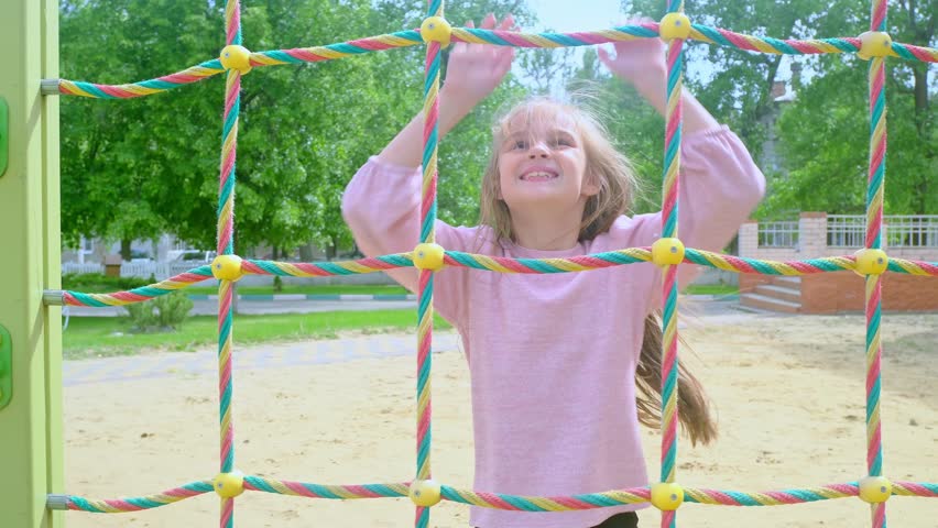 Elementary school child climbing on the school playground