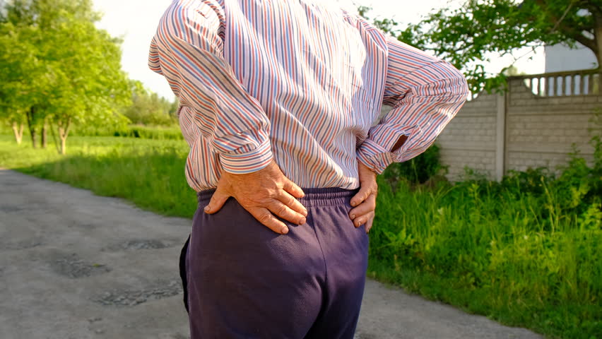 The old woman has a back pain. Selective focus.