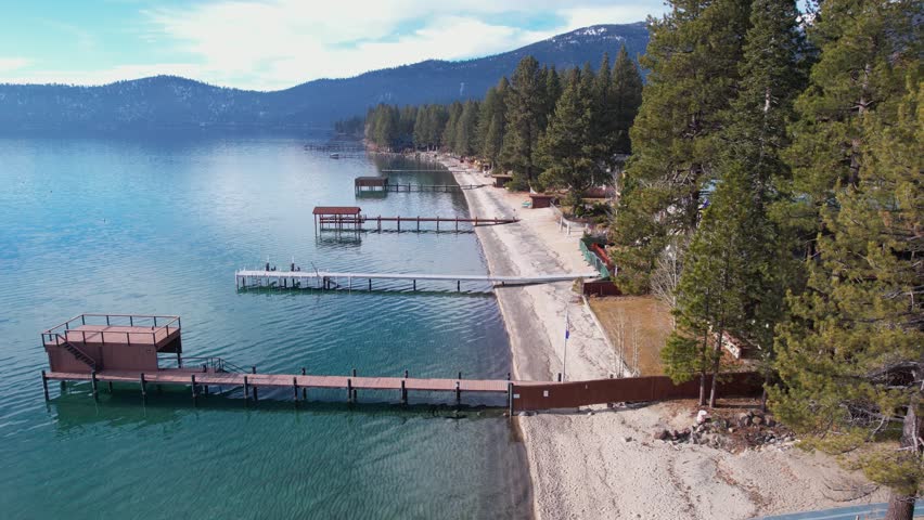Lake Tahoe USA, Drone Shot of Beach, Docks and Pine Trees on Sunny Winter Day
