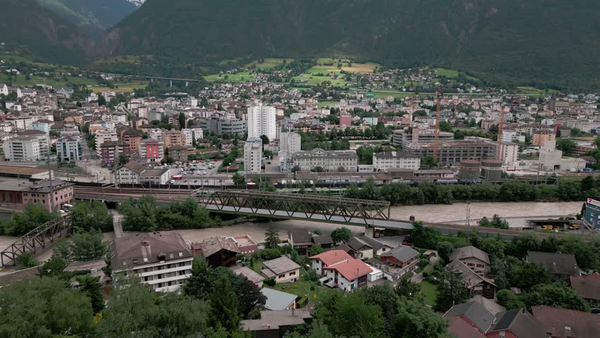 The city in the Alps, Brig in the canton of Valais in Switzerland. The river, Rhone, has a high water level