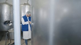 Technician Uses Tablet Device Near Beer Storage Tanks At Brewery. Technician Evaluates Beer Production Process. Alcoholic Drink Storage. Factory Technician. Beer Brewing Industry. Product Storage - Powered by Shutterstock - Get 15% off with code: PIKWIZARD15