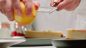Pastry chef adding a lemon zest on classic dessert cheesecake close-up. Cheesecake is a dessert made with a soft fresh cheese , typically cottage cheese, cream cheese, quark or ricotta, eggs, and - Powered by Shutterstock - Get 15% off with code: PIKWIZARD15