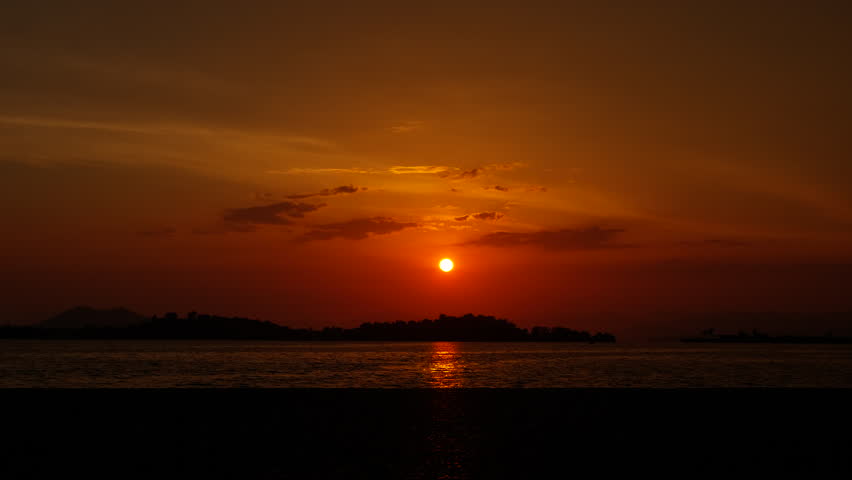 Dancing child silhouette on evening shore. a view of silhouette of dancing girl on shore against colorful sky in summer.