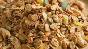 Granola oat breakfast cereals. Healthy vegan morning meal for diet and weight loss. breakfast from oat grains, oatmeal. roasted oats flakes, closeup. - Powered by Shutterstock - Get 15% off with code: PIKWIZARD15