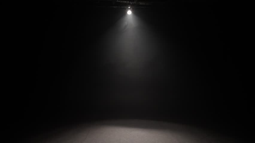 A small theater stage illuminated by a white spotlight.
A strong light illuminates from the darkness.  - Powered by Shutterstock - Get 15% off with code: PIKWIZARD15