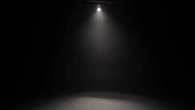 A small theater stage illuminated by a white spotlight.
A strong light illuminates from the darkness.  - Powered by Shutterstock - Get 15% off with code: PIKWIZARD15