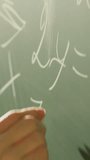 The teacher is utilizing a blackboard in the classroom to instruct students on mathematical concepts including algebra and geometry, as well as subjects like physics and calculations - Powered by Shutterstock - Get 15% off with code: PIKWIZARD15