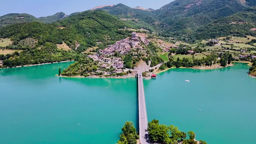 Drone view of the Lake Turano whit the village of Castel di Tora in Lazio, Italy