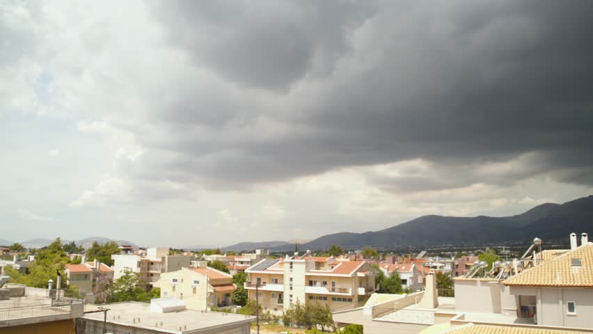 Slow pan, panoramic footage of heavy black clouds over Parnitha mountain, Greece 4K
