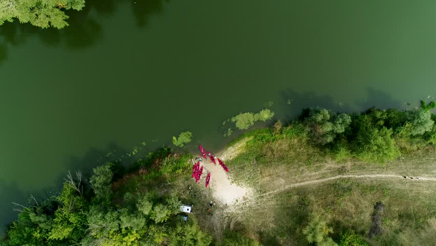 Aerial view: Kayak swimmers go down the river