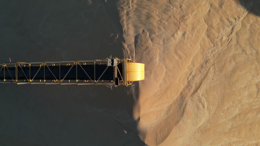 Bulk of wheat grains on harvest industry or Western Australia. Aerial rising top down.
