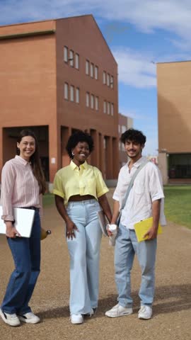 Portrait of three multiethnic students at college campus. Vertical footage.