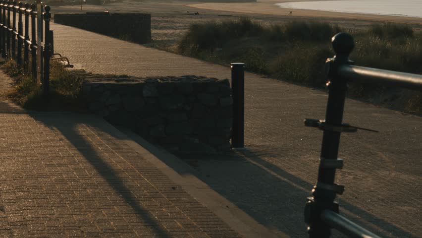 Point of View POV Entering Beach Promenade at Sunrise with Steps and Rails