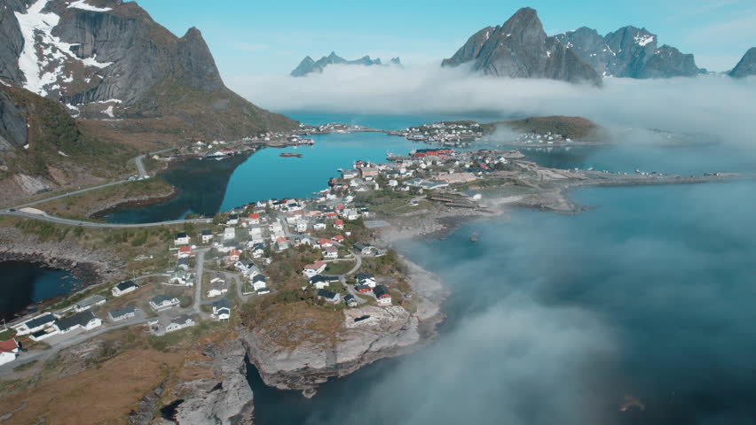 Lofoten Islands, Norway: Aerial Shot over Clouds and Mountains" of the fishing town of Reine. Norway.
