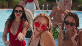 Girls models posing staying in light blue water of swimming pool at summer pool party in bright open bikinis. Women enjoy weekends with friends, screaming songs, flirting with boyfriends. - Powered by Shutterstock - Get 15% off with code: PIKWIZARD15
