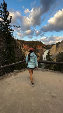 Vertical 4k, Young Woman Lower Falls Lookout in Yellowstone National Park, Wyoming USA