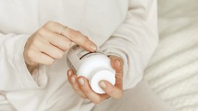 Woman search details about her pills medication. Research reading information about vitamins supplements, side effects or benefits, health care concept. - Powered by Shutterstock - Get 15% off with code: PIKWIZARD15