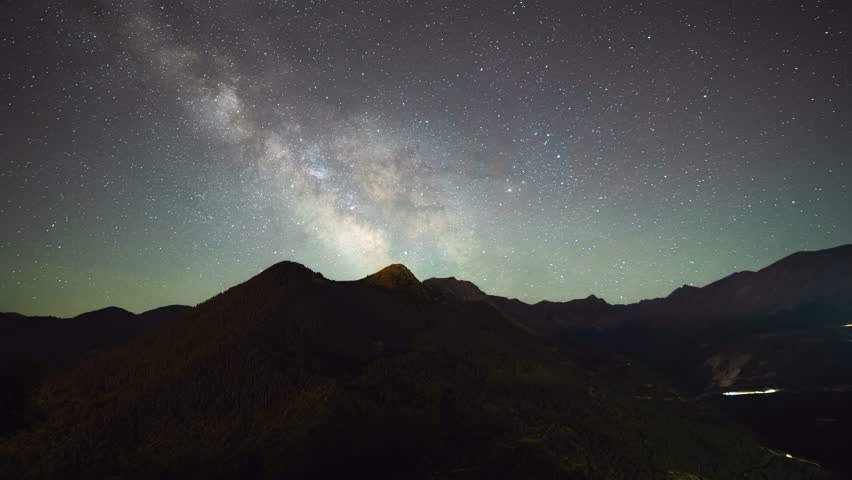 Time Lapse Milky way galaxy core rising over Mountain peaks clear sky summer