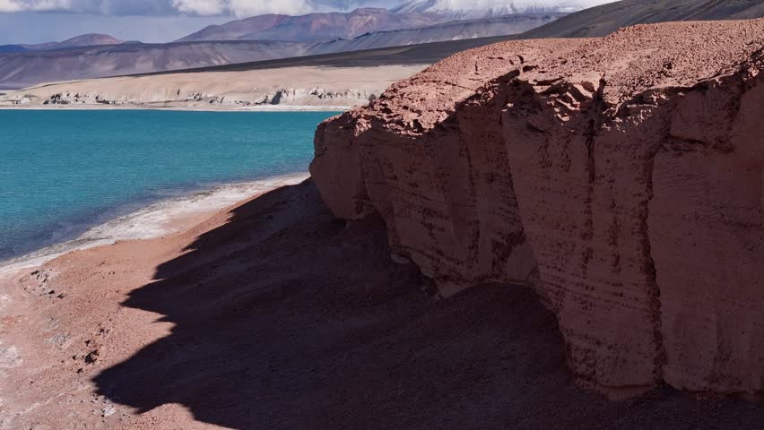 Blue lagoon near Ojos del Salado volcano in Chile South America majestic nature volcanic landscape. Aerial view of blue lagoon by Ojos del Salado volcano in Chile grandeur of South American nature