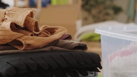 Close up of volunteers sorting donated clothes in charity shop. Team of workers unpacking boxes with clothes in second hand store. Charity and donation concept. Group of volunteers. - Powered by Shutterstock - Get 15% off with code: PIKWIZARD15