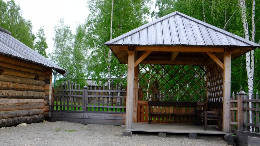 Wooden gazebo, pergola in the garden, back yard. Place for rest