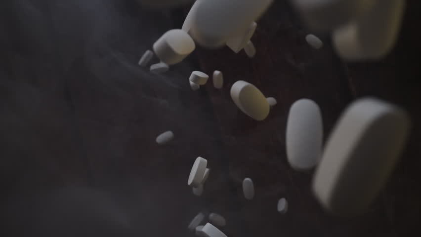 White pills on black backdrop, focus on air, health