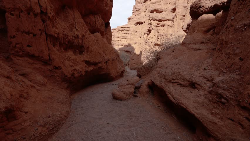 Walking on red rock canyon in Kyrgyzstan