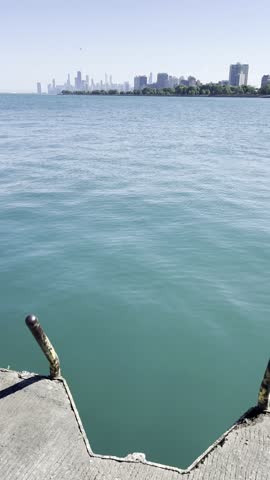 A Tranquil Morning at the Lakeshore in Chicago, Illinois with Skyline in the background with rocks getting splashed.