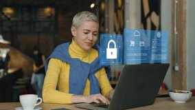 Woman working on a laptop in a cafe, interacting with a digital interface showcasing data protection and secure login. VPN, Internet cyber security - Powered by Shutterstock - Get 15% off with code: PIKWIZARD15