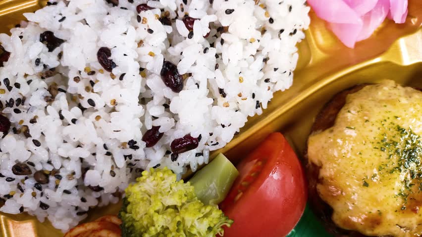 Five-grain rice lunch box close up, rotating