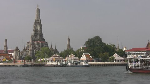 The cross river ferry travels towards Wat Arun, The Temple of the Dawn, in Bangkok.